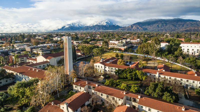 Aerial view of campus with the snow-capped San Gabriel Mountains in the background.